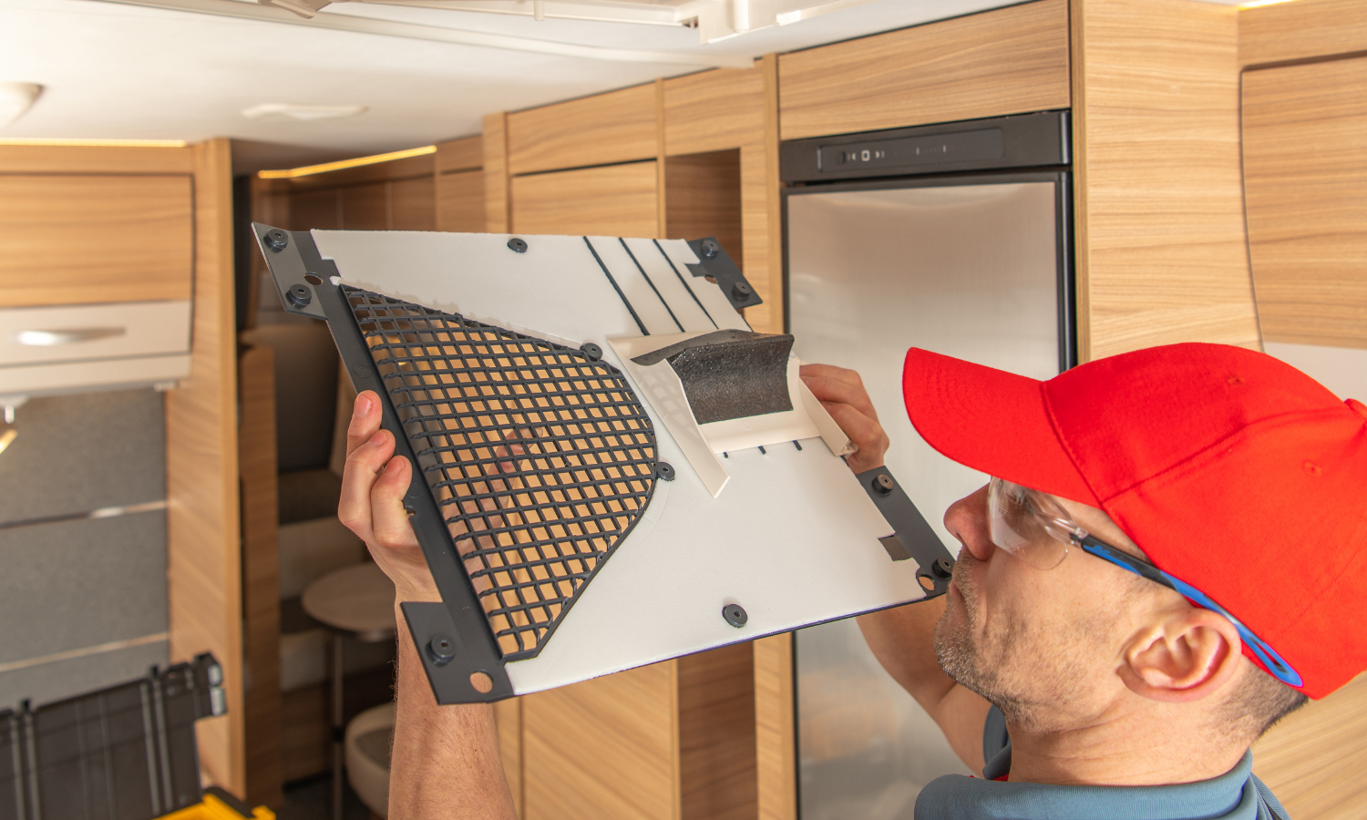 RV camper working on air conditioning maintenance